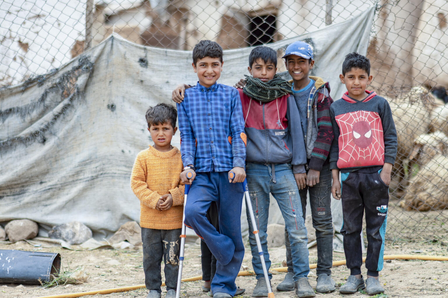 Jumaa, 12, with his friends and siblings in Abu Abdeh village, east rural Aleppo, Syria, on 19 April 2022. “I was collecting truffles with my family when I stepped on the mine,” said Jumaa, 12, recalling the time he lost his foot a year ago. Photo credit: UNICEFAdel Janji&nbsp;UN0646048